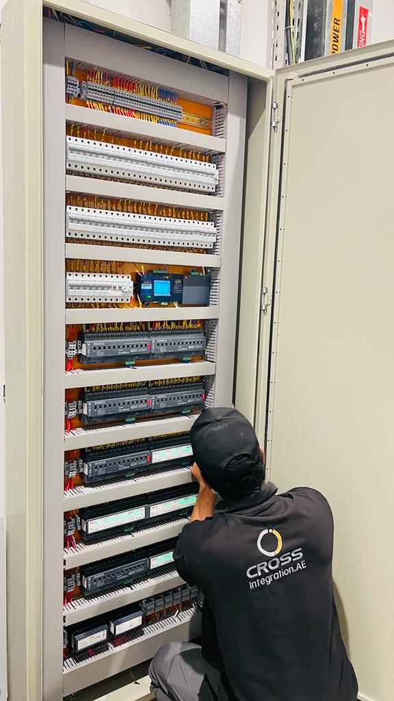 Cross Integration technician working on a home automation control panel